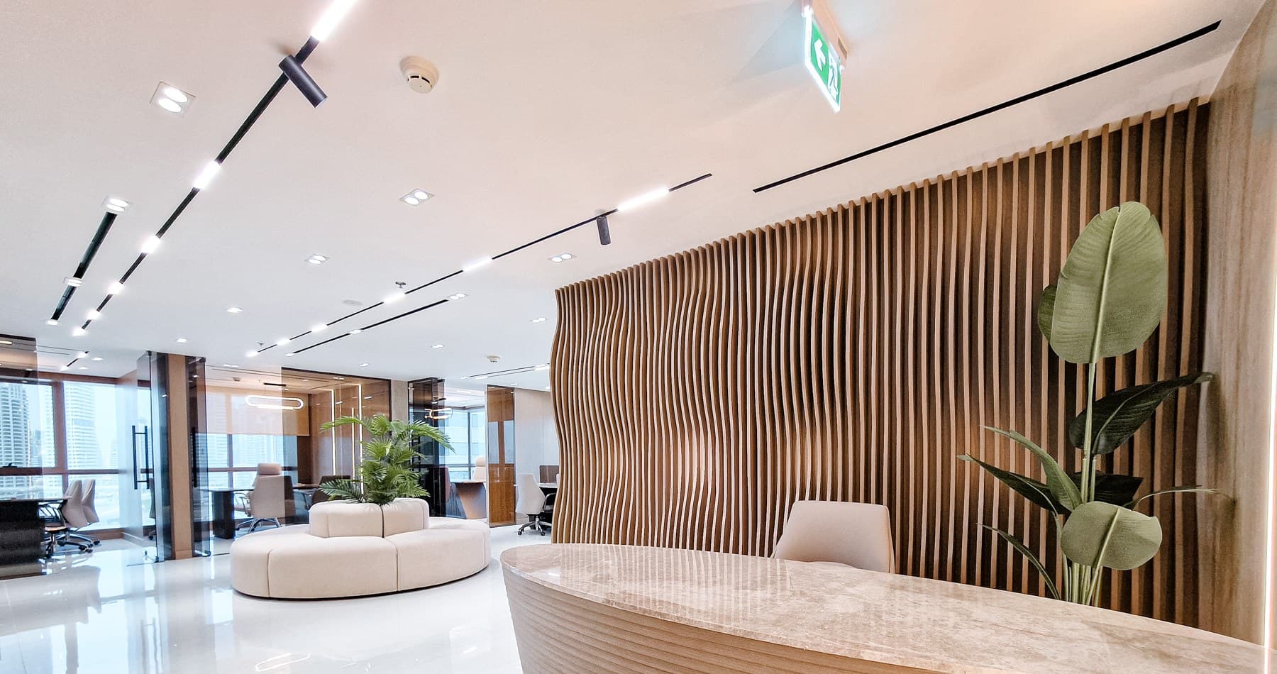 The reception, with the rippled timber wall and the meeting rooms beyond