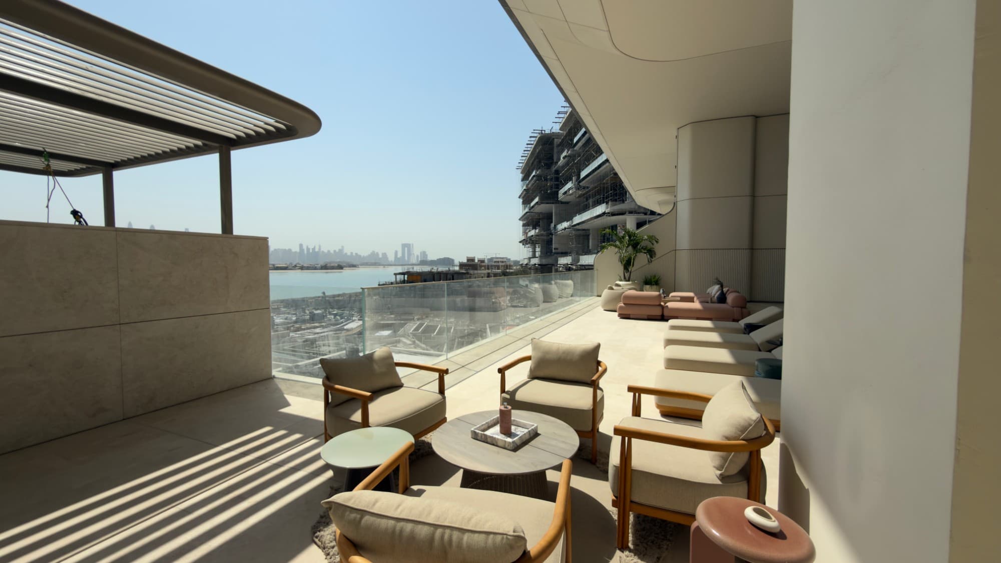 Seating on the terrace, with the skyline beyond the glass balustrade