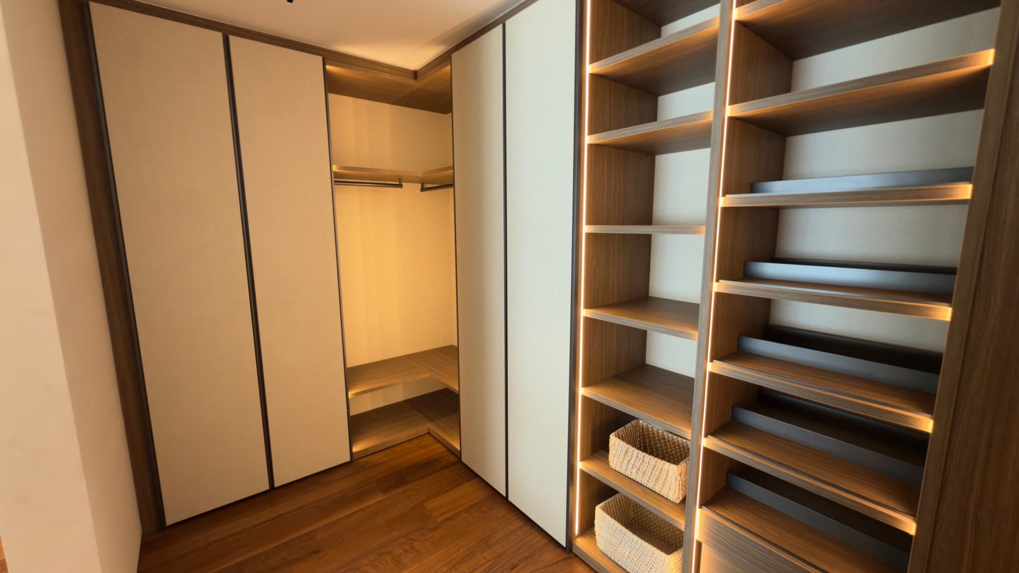 The walk-in dressing room, lit joinery on both sides