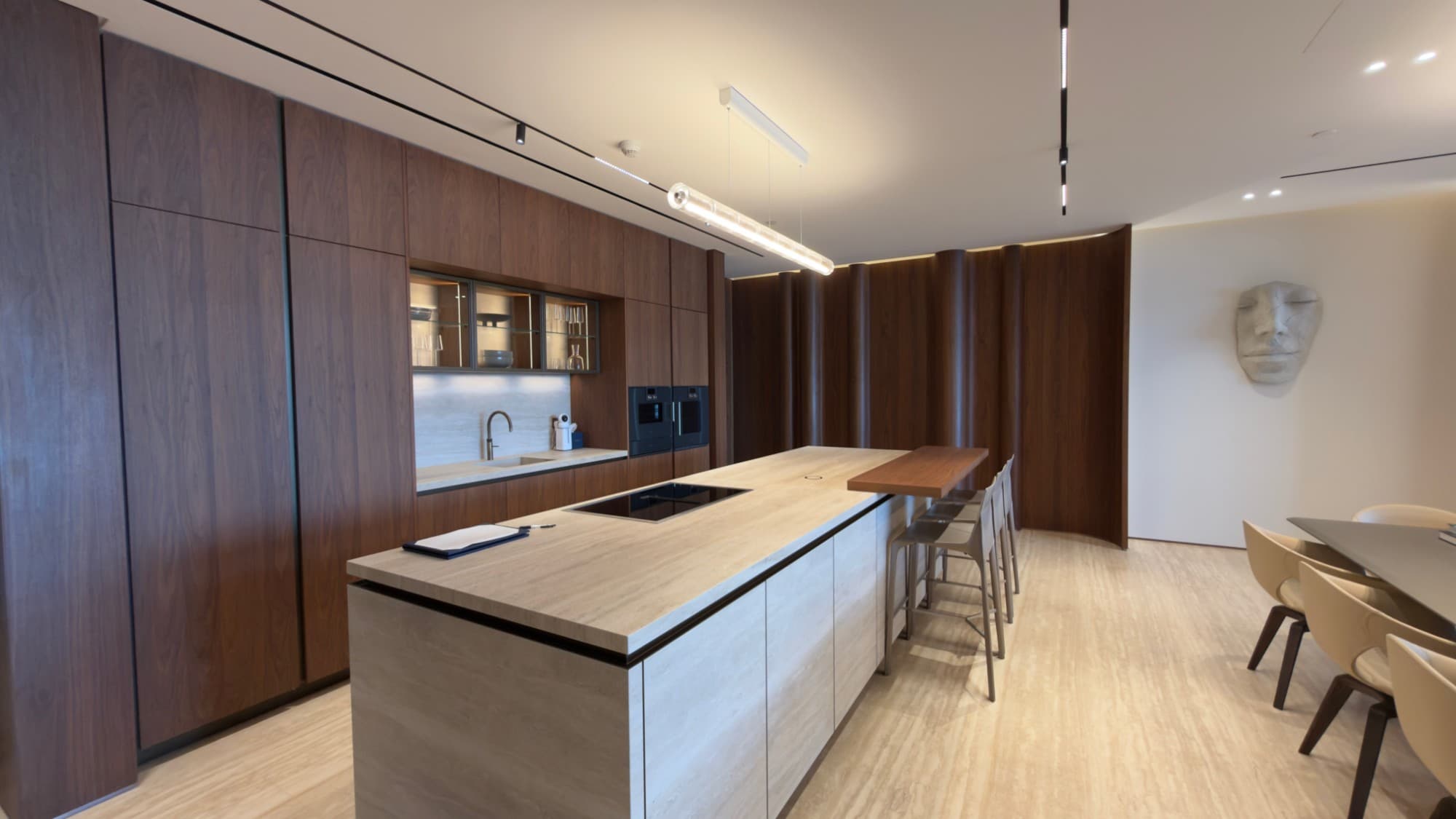 The kitchen island and its counter seating, against walnut joinery