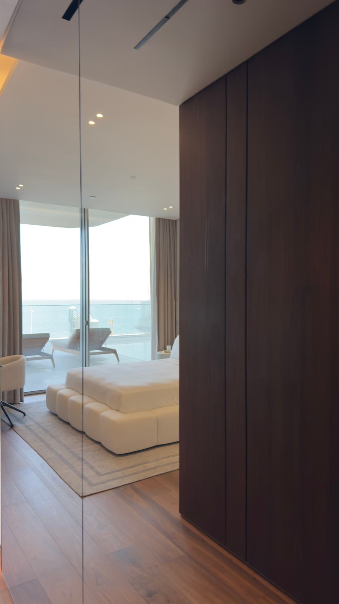 Wardrobe joinery beside a bedroom, with the terrace in the mirror